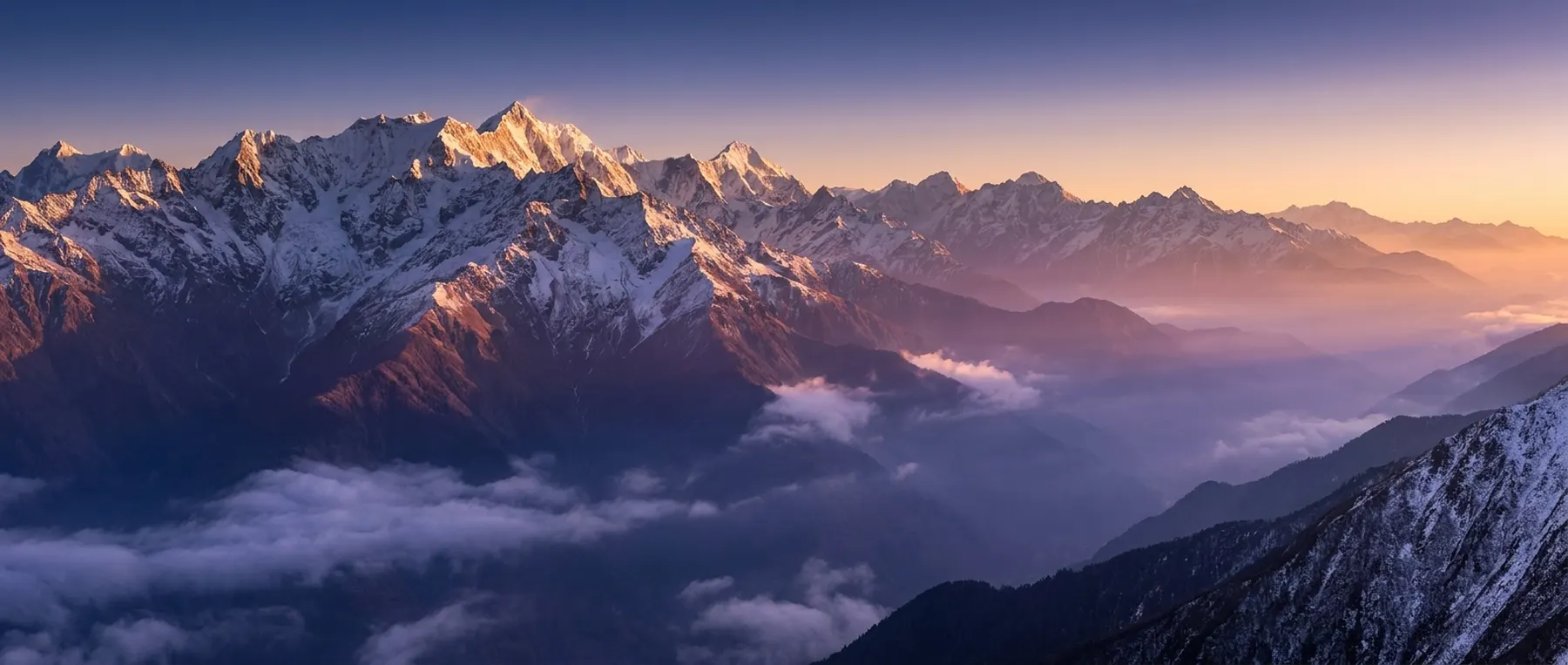 Snow-capped mountain range at dawn